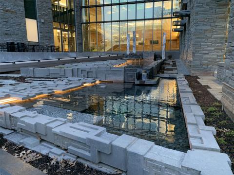 Outdoor public art installation of blocks around water