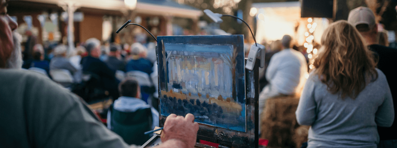 Person painting an outdoor crowd