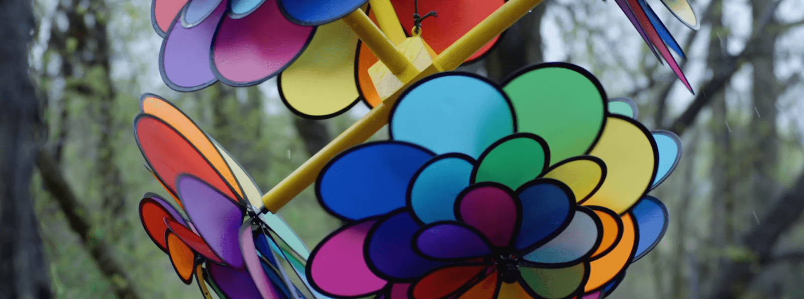 A close up of a rainbow covered pinwheel with three prongs