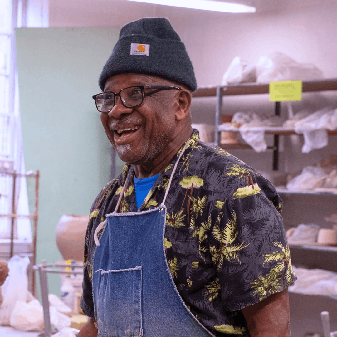 Ceramicist and 2025 Heritage Award winner Sam Wallace pictured smiling in Baltimore Clayworks classroom