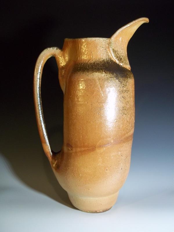 A hand-thrown and altered pitcher, this piece was fired in a wood-kiln with beautiful ash buildup. These work received top honors at in a regional ceramics gallery and is now a permanent collection. 