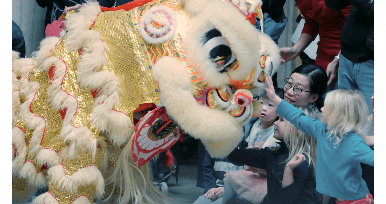 Chinese New Year dragon being pet by a child