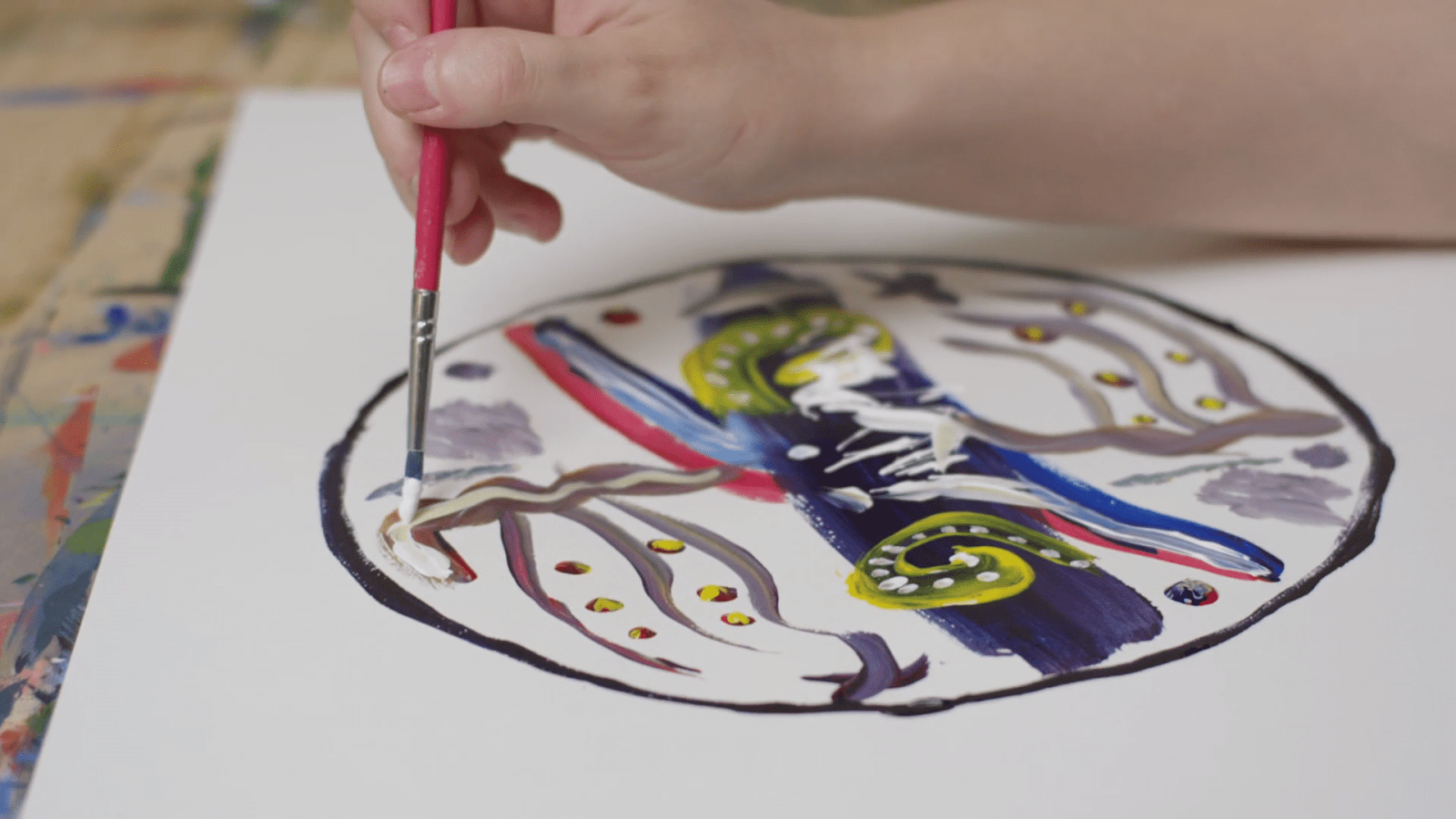 Close up of a hand drawing a round abstract object