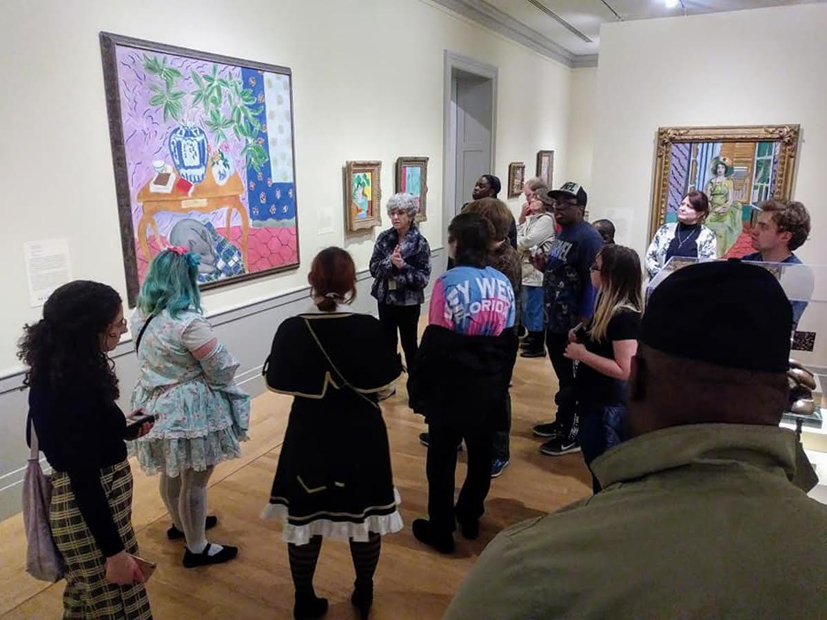 Crowd of people attend an art gallery opening